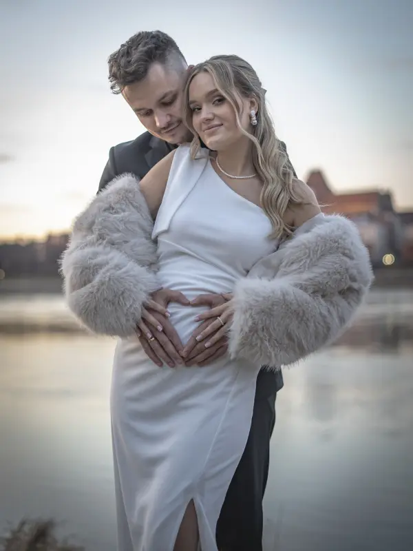 Romantyczna sesja ślubna nad Wisłą w Toruniu – para młoda w objęciach