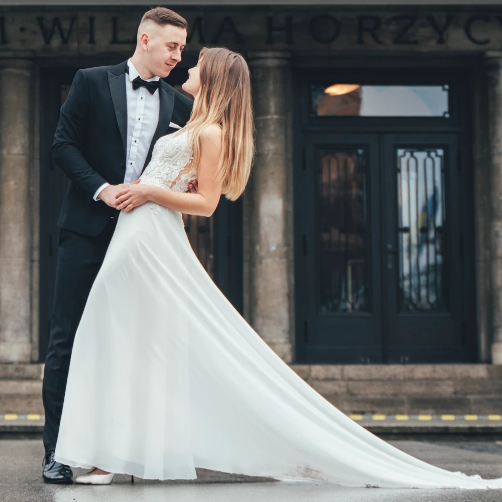Sesja ślubna Toruń – Para Młoda w eleganckiej pozie przed Teatrem im. Wilama Horzycy